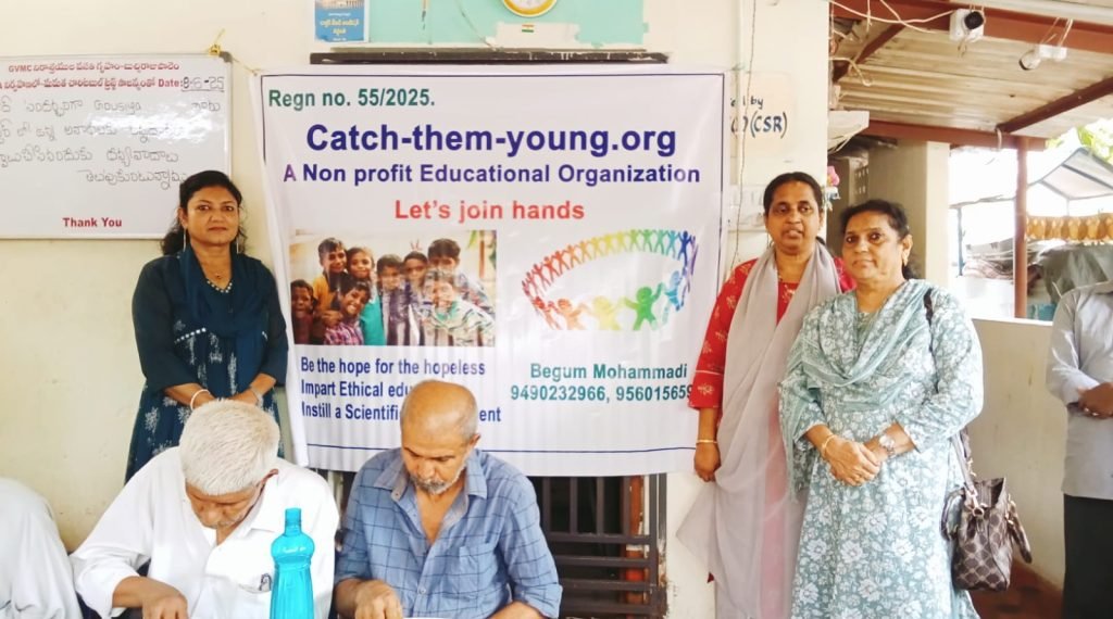 Team members of Catch You Young standing beside their registration and mission banner