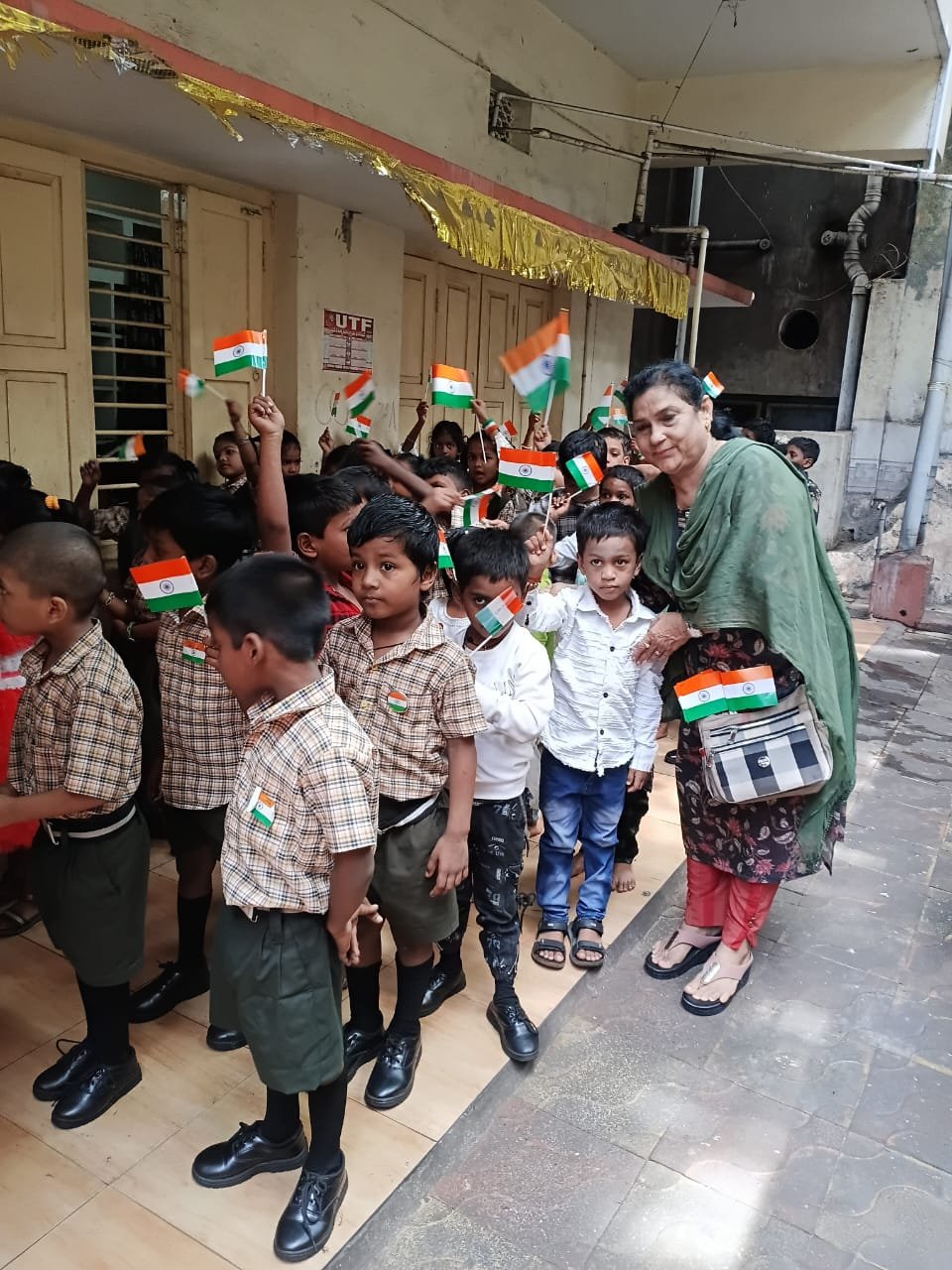 Teachers and students taking part in an interactive workshop, waving Indian flags